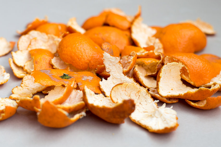 citrus orange peels laying on a white background